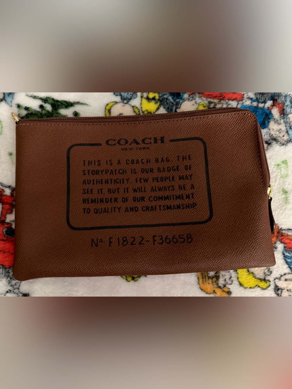 Coach Brown Leather Wrist Zip Pouch with Creed in Black Logo Print. Wrist Strap.